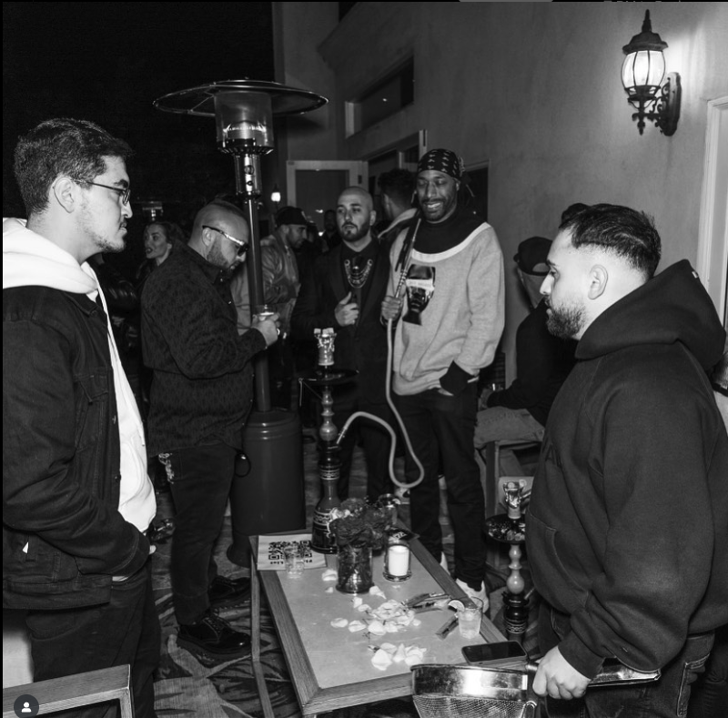 Outdoor lounge hookah setup at sunset